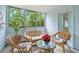 Cozy sunroom with wicker furniture, plants, and views of the outdoors at 212 Brittany Ct, Duluth, GA 30096