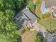 Aerial view of a traditional two-story brick home featuring a well-manicured lawn and a long driveway at 2346 Unicoi Ct, Duluth, GA 30097