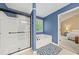 Bright bathroom with a tub and shower with doors next to a door that leads to the main bedroom at 2346 Unicoi Ct, Duluth, GA 30097