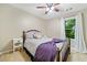 Cozy bedroom features a ceiling fan, window with natural light and neutral colored walls at 2346 Unicoi Ct, Duluth, GA 30097