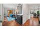 Open-concept dining room with hardwood floors, a large wooden hutch, and a view into the adjacent kitchen at 2346 Unicoi Ct, Duluth, GA 30097