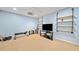 Home gym with bench, TV, industrial shelving and mounted weights at 2346 Unicoi Ct, Duluth, GA 30097