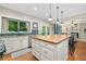 Spacious kitchen with a butcher block island, white cabinets, and a view into the adjacent living area at 2346 Unicoi Ct, Duluth, GA 30097
