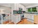 Bright kitchen featuring white cabinets, stainless steel appliances, and a view into an adjacent ' play area at 2346 Unicoi Ct, Duluth, GA 30097