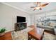 Cozy living room offering hardwood floors, a fireplace, large windows, and access to the kitchen at 2346 Unicoi Ct, Duluth, GA 30097