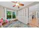 Play room bathed in natural light with blue rug and view of a gourmet kitchen at 2346 Unicoi Ct, Duluth, GA 30097
