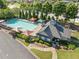 Aerial view of a community pool area with lounge chairs, umbrellas, and a clubhouse at 2346 Unicoi Ct, Duluth, GA 30097