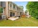 Spacious backyard with a patio, table, chairs, and lush green lawn at 2349 Northlake Ne Ct, Atlanta, GA 30345