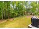 Large backyard with mature trees, a patio, grill, and lots of green space at 2349 Northlake Ne Ct, Atlanta, GA 30345