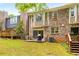 Backyard with a patio, grill, table and chairs surrounded by a lush lawn and mature trees at 2349 Northlake Ne Ct, Atlanta, GA 30345