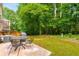 Backyard with a patio, outdoor furniture, grill, and lots of shade trees at 2349 Northlake Ne Ct, Atlanta, GA 30345