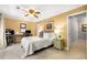 Bedroom with yellow walls features a ceiling fan, closet, and desk with home office equipment at 2349 Northlake Ne Ct, Atlanta, GA 30345