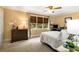 Cozy bedroom showcases a large window, desk with computer, dresser, and a ceiling fan at 2349 Northlake Ne Ct, Atlanta, GA 30345