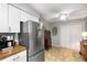 Kitchen boasts stainless steel refrigerator, white cabinets, tile floors, and a ceiling fan at 2349 Northlake Ne Ct, Atlanta, GA 30345