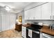 Kitchen with white cabinetry, stainless steel stove, and tiled floor at 2349 Northlake Ne Ct, Atlanta, GA 30345