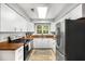 Well-lit kitchen features white cabinets, stainless steel appliances, and a window view at 2349 Northlake Ne Ct, Atlanta, GA 30345