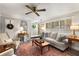Bright and airy living room with comfortable seating, plantation shutters, and a ceiling fan at 2349 Northlake Ne Ct, Atlanta, GA 30345
