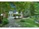Charming backyard with well-maintained lawn, lush greenery, stone pathway and seating at 5490 Chemin De Vie, Sandy Springs, GA 30342