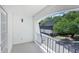The home's balcony offers a view of the surrounding trees and neighboring structures at 5490 Chemin De Vie, Sandy Springs, GA 30342