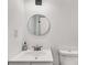 Bright bathroom features a toilet, sink and gold framed mirror at 5490 Chemin De Vie, Sandy Springs, GA 30342