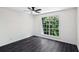 Bright bedroom features a ceiling fan, sleek flooring, and a large window with green views at 5490 Chemin De Vie, Sandy Springs, GA 30342