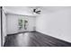 Open bedroom with hardwood floors, ceiling fan and sliding glass door at 5490 Chemin De Vie, Sandy Springs, GA 30342