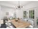 Bright dining room with a modern light fixture and seating for six at 5490 Chemin De Vie, Sandy Springs, GA 30342
