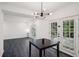 Dining room with pendant lighting, gray floors, and doors to the outside at 5490 Chemin De Vie, Sandy Springs, GA 30342