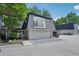 A townhouse featuring a two-car garage, and an open balcony on the upper level at 5490 Chemin De Vie, Sandy Springs, GA 30342