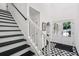 Bright foyer featuring black and white patterned tile, staircase, and front door at 5490 Chemin De Vie, Sandy Springs, GA 30342