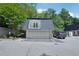 Charming townhome featuring a two-car garage and balcony overlooking the parking area at 5490 Chemin De Vie, Sandy Springs, GA 30342