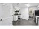 Efficient kitchen with modern appliances and black countertops, adjoining dining area at 5490 Chemin De Vie, Sandy Springs, GA 30342