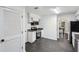 Bright kitchen with white cabinets, stainless steel appliances, and gray floors at 5490 Chemin De Vie, Sandy Springs, GA 30342