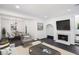 Bright living room features dark floors, modern decor, and a cozy fireplace at 5490 Chemin De Vie, Sandy Springs, GA 30342