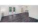 Bright living room with gray floors, double doors, and stylish lighting fixture at 5490 Chemin De Vie, Sandy Springs, GA 30342