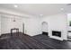 Bright living room with wood floors, a fireplace, and modern lighting at 5490 Chemin De Vie, Sandy Springs, GA 30342