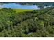 Aerial view showcasing the tree coverage of the home and its proximity to the lake at 6026 Belle Meade Ct, Villa Rica, GA 30180