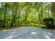 Picture of the backyard concrete patio and beautiful, lush, wooded scenery at 6026 Belle Meade Ct, Villa Rica, GA 30180