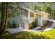 Home featuring a patio, backyard, with mature trees, and a partial covered deck at 6026 Belle Meade Ct, Villa Rica, GA 30180
