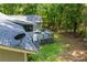 A spacious backyard featuring a large deck, screened in porch, and lush greenery at 6026 Belle Meade Ct, Villa Rica, GA 30180