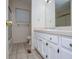Bathroom featuring a white vanity, tiled floors, and a shower-tub combo, blending essential amenities with a neutral color palette at 6026 Belle Meade Ct, Villa Rica, GA 30180