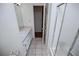 Bright bathroom featuring tiled floors, shower and vanity sink at 6026 Belle Meade Ct, Villa Rica, GA 30180