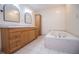 Bathroom with tiled floor, soaking tub and double sinks with cabinetry at 6026 Belle Meade Ct, Villa Rica, GA 30180