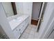 Neat bathroom featuring a white vanity, tiled flooring, and a well-lit mirror, designed for comfort and daily routines at 6026 Belle Meade Ct, Villa Rica, GA 30180