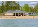 A picturesque lakefront clubhouse with sandy beach, perfect for relaxation and recreation at 6026 Belle Meade Ct, Villa Rica, GA 30180