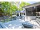 Deck with screened-in porch and stairs leading to back yard and wooded surroundings at 6026 Belle Meade Ct, Villa Rica, GA 30180
