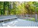 Deck with built-in benches, with view to back yard and wooded surroundings at 6026 Belle Meade Ct, Villa Rica, GA 30180