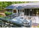 Back deck with screened-in porch, surrounded by mature trees, offering privacy at 6026 Belle Meade Ct, Villa Rica, GA 30180