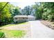 Charming home featuring a welcoming front porch, a two-car garage, and mature trees at 6026 Belle Meade Ct, Villa Rica, GA 30180