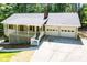 Inviting home exterior with a covered porch and a convenient two-car garage at 6026 Belle Meade Ct, Villa Rica, GA 30180